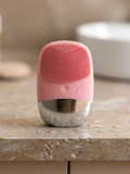 Norevella SonicClean rechargeable silicone facial cleansing brush in premium skincare setting